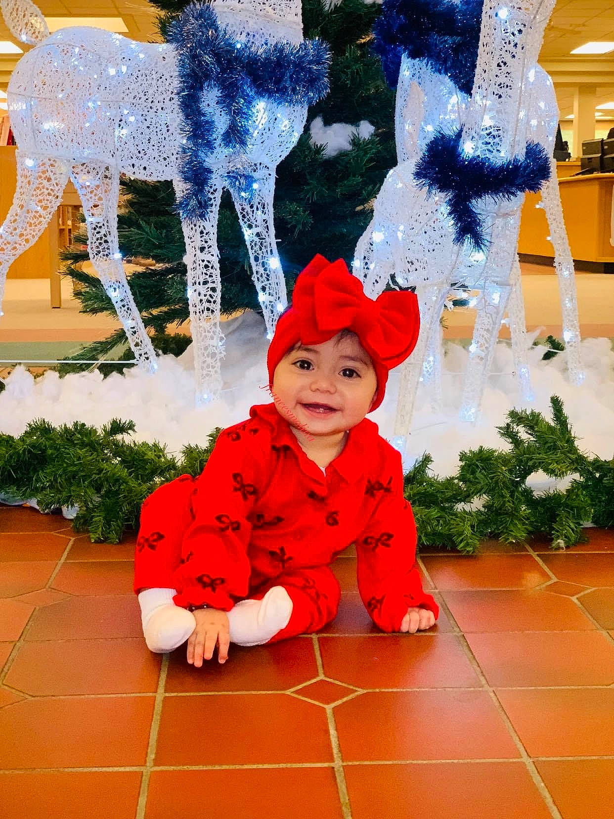 Eliza joined the competition — help win amazing prizes! art, christmas, christmas_decoration, christmas_ornament, event, flooring, green, happy, hat, headwear, holiday, joy, mammal, person, plant, red, santa_claus, textile, toddler, tree