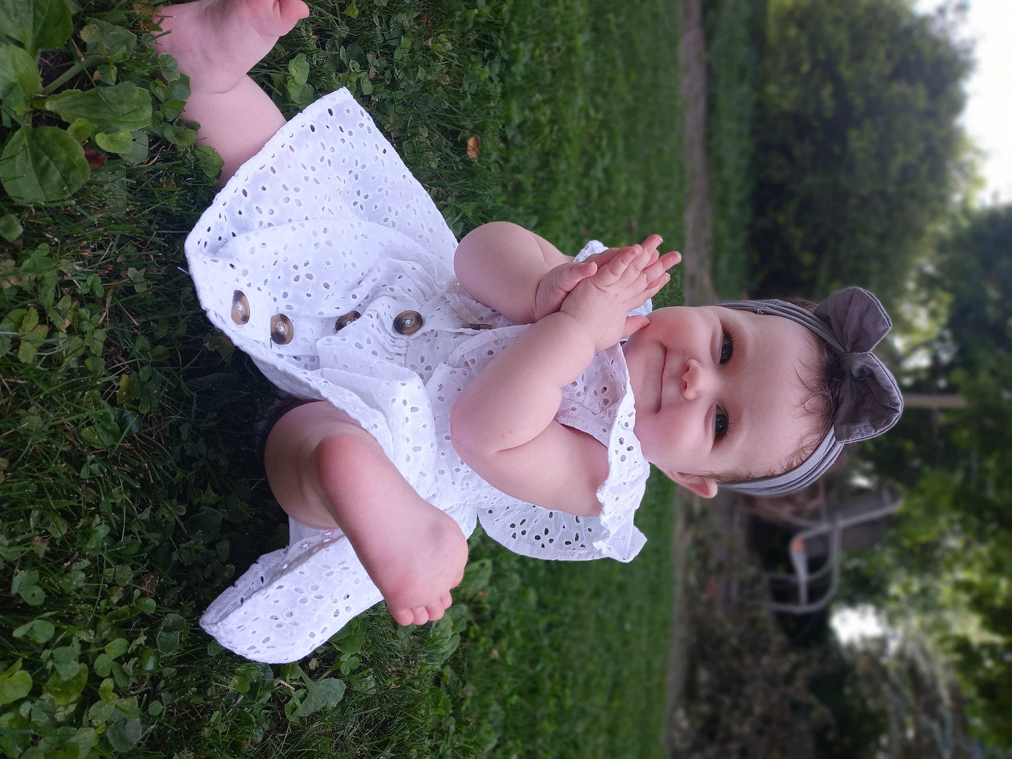 Quinn is registered to the contest to win money with this photo: baby_toddler_clothing, child, dress, embellishment, fashion_accessory, fun, glove, grass, happy, human_leg, joy, pattern, people_in_nature, person, pink, plant, shoe, smile, thigh, toddler