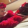 Sailey participe au concours pour gagner de l'argent avec cette photo : baby, child, red_dress, headband, bow, roses, bouquet, bed, soft_lighting, portrait, cute, flower_arrangement, indoors, smiling, toddler, fancy_clothing, happy, closeup, person, celebration