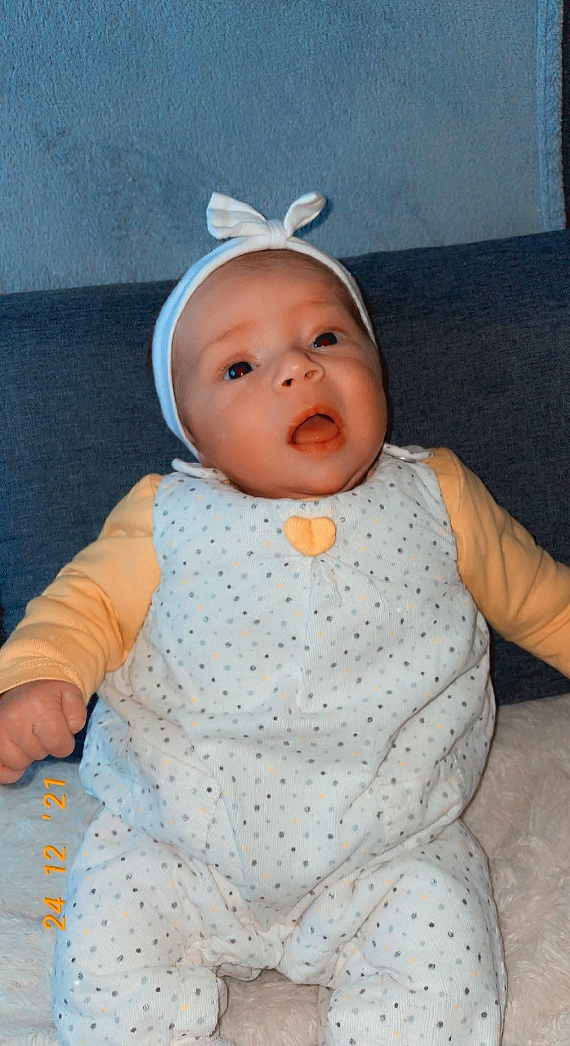 Sherryl participe au concours pour gagner de l'argent avec cette photo : baby, baby_products, baby_toddler_clothing, cap, cheek, child, comfort, costume_hat, fashion_accessory, head, headband, headpiece, headwear, infant_bodysuit, iris, linens, pattern, person, sitting, sleeve