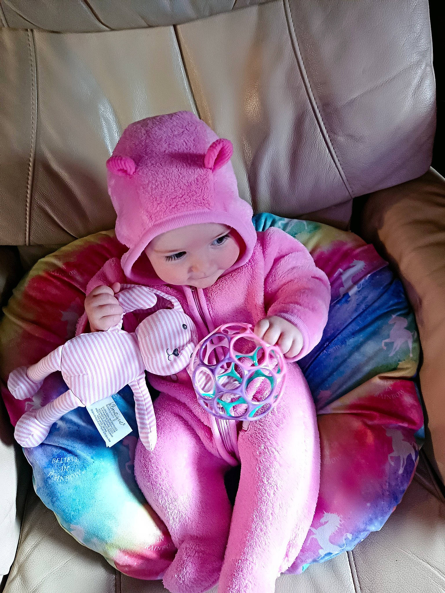 Cora is registered to the contest to win money with this photo: arm, baby, baby_products, baby_sleeping, baby_toddler_clothing, car_seat, child, comfort, facial_expression, headgear, headwear, leg, linens, magenta, mouth, person, pink, purple, sitting, stuffed_toy