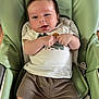 baby, infant, smiling, child, tshirt, shorts, seat, baby_chair, cushion, happy, cute, comfort, indoor, person, young_child, clothing, face, skin, sitting, expression