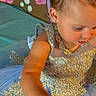 background, blue, bow, bubbles, celebration, child, costume, curious, dress, earrings, face, girl, gold, hair, hand, indoor, portrait, seashells, sparkles, toddler