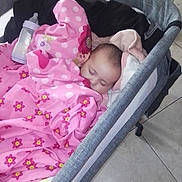 Emery joined the competition — help win amazing prizes! baby, sleeping, blanket, pink, flower_pattern, bassinet, bottle, indoor, tiled_floor, table, fruit_bowl, cozy, child, resting, infant, home, comfort, soft, peaceful, nursery