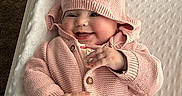 Emery joined the competition — help win amazing prizes! baby, smiling, knitted_hat, pink_clothing, baby_boy, baby_girl, blanket, nursery, baby_care, infant, cute, happy, child, soft_texture, baby_garment, hand, face, lying_down, indoors, cozy