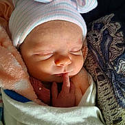 Lilly is registered to the contest to win money with this photo: newborn, baby, sleeping, infant, hat, blanket, wrapped, finger, cute, soft, peaceful, closeup, child, portrait, resting, cozy, face, headwear, warm, indoors