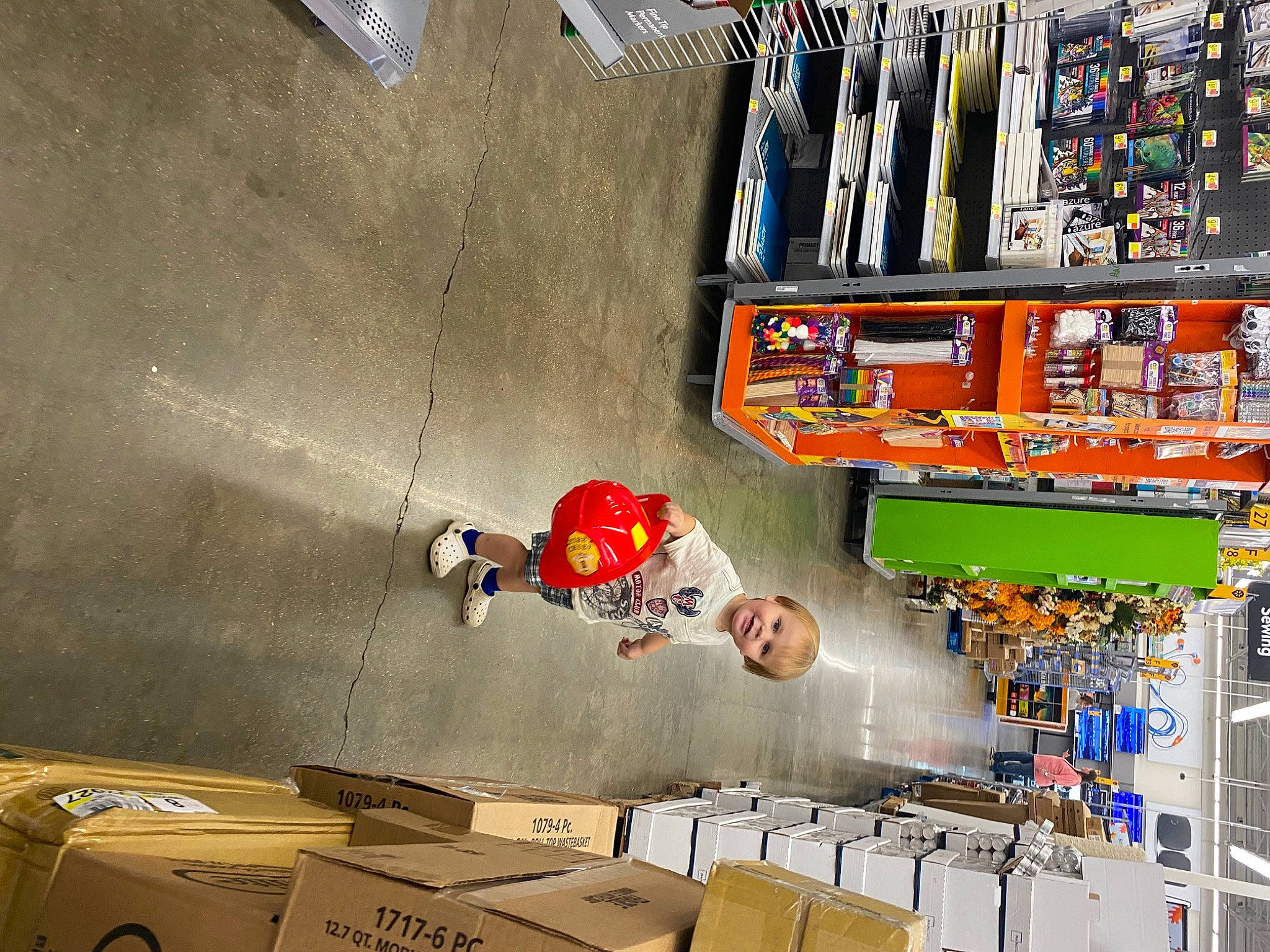 Nathaniel is registered to the contest to win money with this photo: art, carton, ceiling, concrete, engineering, fun, games, line, machine, orange, person, recreation, room, shelving, shipping_box, snapshot, space, tire, wall, wood
