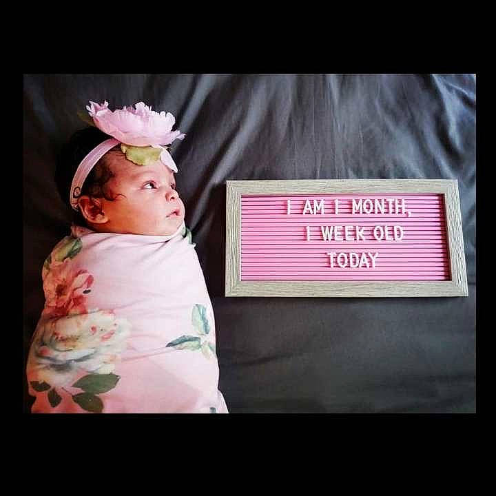 Aleigha is registered to the contest to win money with this photo: baby, baby_toddler_clothing, child, fashion_accessory, flower, font, gesture, happy, headband, headpiece, linens, magenta, peach, person, petal, pink, plant, rose_family, selfie, sleeve