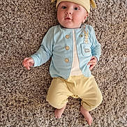 Leo joined the competition — help win amazing prizes! baby, infant, child, carpet, floor, hat, clothing, blue_jacket, yellow_pants, peter_rabbit, cute, lying_down, indoors, soft_texture, feet, hand, face, eyes, headwear, smile