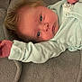 Shawn is registered to the contest to win money with this photo: baby, bed, blanket, bodypart, clothing, couch, face, finger, furniture, hand, happy, head, knitwear, newborn, person, photography, portrait, quilt, smile, sweater