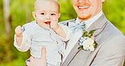Gunner is registered to the contest to win money with this photo: baby, boutonniere, bow_tie, child, cowboy_hat, footwear, forest, formal_wear, greenery, happy, holding, light, man, nature, outdoor, person, portrait, smile, suit, vest
