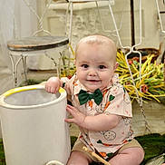 Gunner joined the competition — help win amazing prizes! animal, baby, bucket, carrot_pattern, chair, child, cute, decor, easter_eggs, flowers, green_bow_tie, indoor, moss, paintbrush, rabbit, shirt, shoes, sitting, smiling, table
