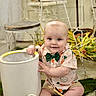 animal, baby, bucket, carrot_pattern, chair, child, cute, decor, easter_eggs, flowers, green_bow_tie, indoor, moss, paintbrush, rabbit, shirt, shoes, sitting, smiling, table