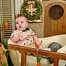 Gunner is registered to the contest to win money with this photo: armchair, baby, bunny_pattern, carrot, child, cute, decorations, fabric_carrot, floor_grass, greenery, indoor, neutral_colors, plush_toy, portrait, rabbit, relaxed, stick, wooden_fence, wreath, young_child