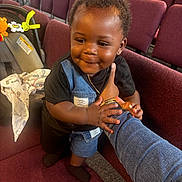 Dezakai joined the competition — help win amazing prizes! toddler, child, smiling, denim, black_shirt, maroon_chair, auditorium, car_seat, toy, baby, holding_arm, earrings, short_hair, indoor, person, cute, portrait, happy, clothing, seat