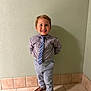 Arthur is registered to the contest to win money with this photo: child, boy, smile, shirt, tie, pants, shoes, standing, indoor, wall, tile_floor, happy, portrait, cute, fashion, casual, young, person, clothing, feet