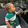 Arthur joined the competition — help win amazing prizes! toddler, child, flower, kissing, green_shorts, green_shirt, white_shoes, bracelet, wicker_chair, cushion, indoor, portrait, cute, puckered_lips, short_hair, hand, plant, seat, smile, person
