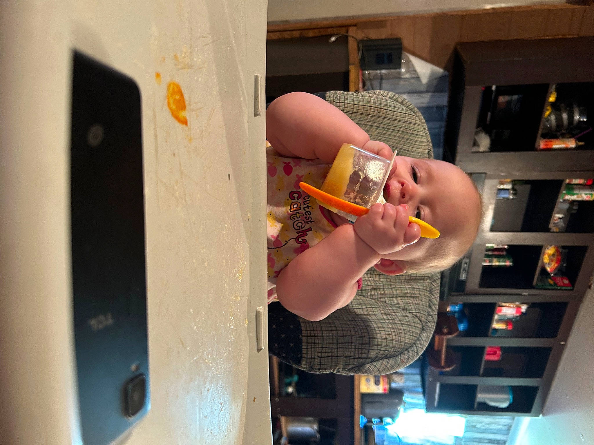 Sabrina joined the competition — help win amazing prizes! alcohol, audio_equipment, communication_device, display_device, drink, finger, fun, gadget, gesture, kitchen_appliance, machine, major_appliance, person, portable_communications_device, refrigerator, room, shelf, shelving, tableware, toy