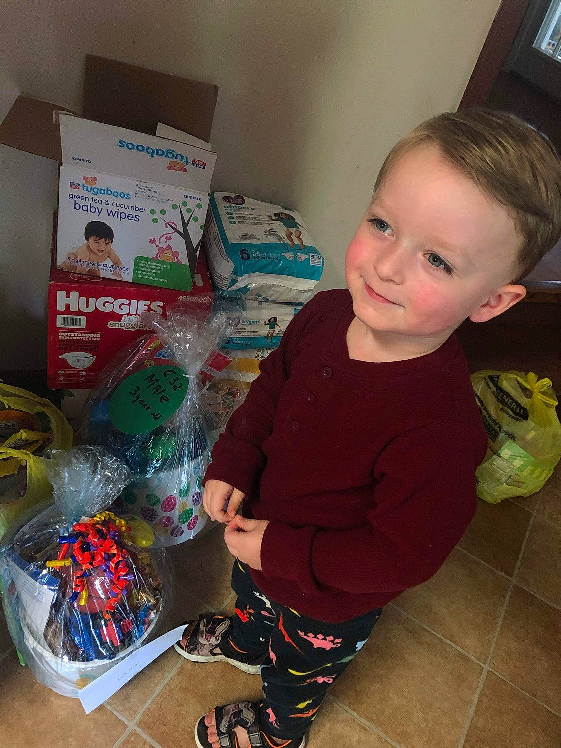 William joined the competition — help win amazing prizes! baby, baby_toddler_clothing, box, child, christmas, flooring, fun, holiday, joy, packaging_and_labeling, packing_materials, person, picture_frame, plastic, plastic_bag, play, room, sitting, sleeve, smile