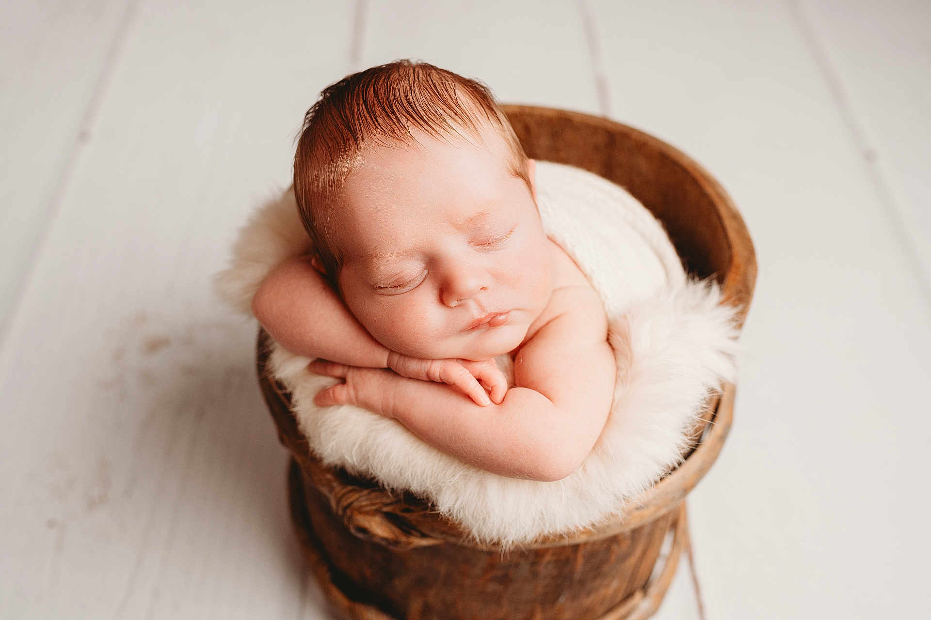 Jack joined the competition — help win amazing prizes! newborn, baby, sleeping, wooden_bucket, fluffy_blanket, arms_folded, peaceful, infant, cute, portrait, close_up, resting, soft_lighting, wood_floor, cozy, skin, head, tiny_hands, indoor, adorable