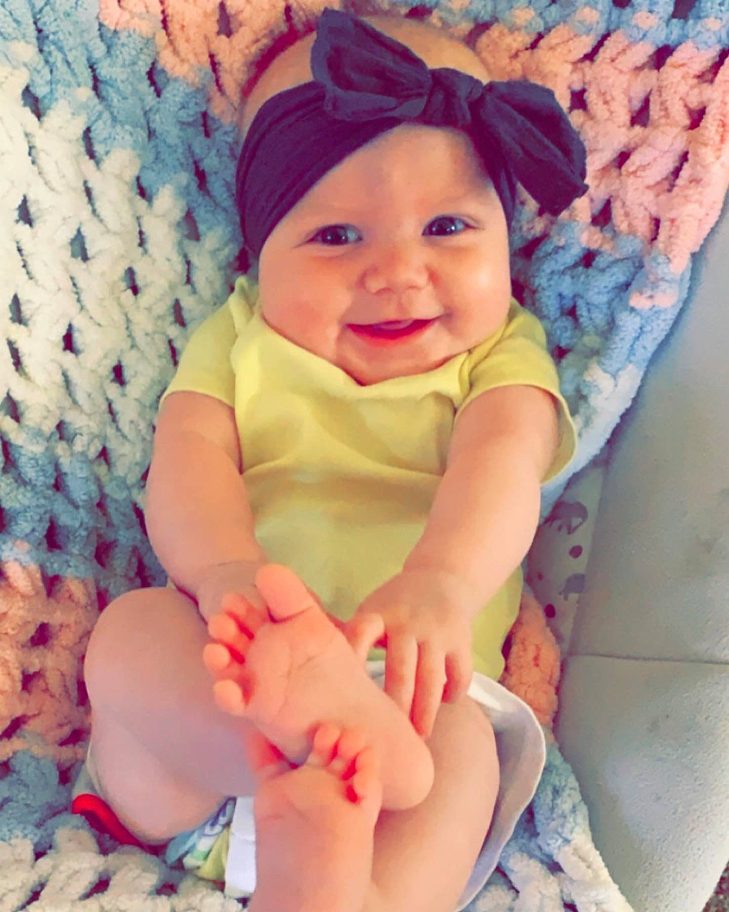 Kenadee is registered to the contest to win money with this photo: baby, baby_products, baby_toddler_clothing, beauty, cheek, child, finger, foot, hand, headgear, headwear, human_leg, joy, leg, pattern, person, pink, product, sitting, skin