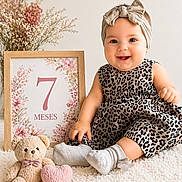 Victoria joined the competition — help win amazing prizes! baby, infant, child, portrait, smiling, sitting, headband, bow, dress, leopard_print, socks, teddy_bear, heart, milestone_photo, seven_months, flowers, blanket, nursery, indoor, happy
