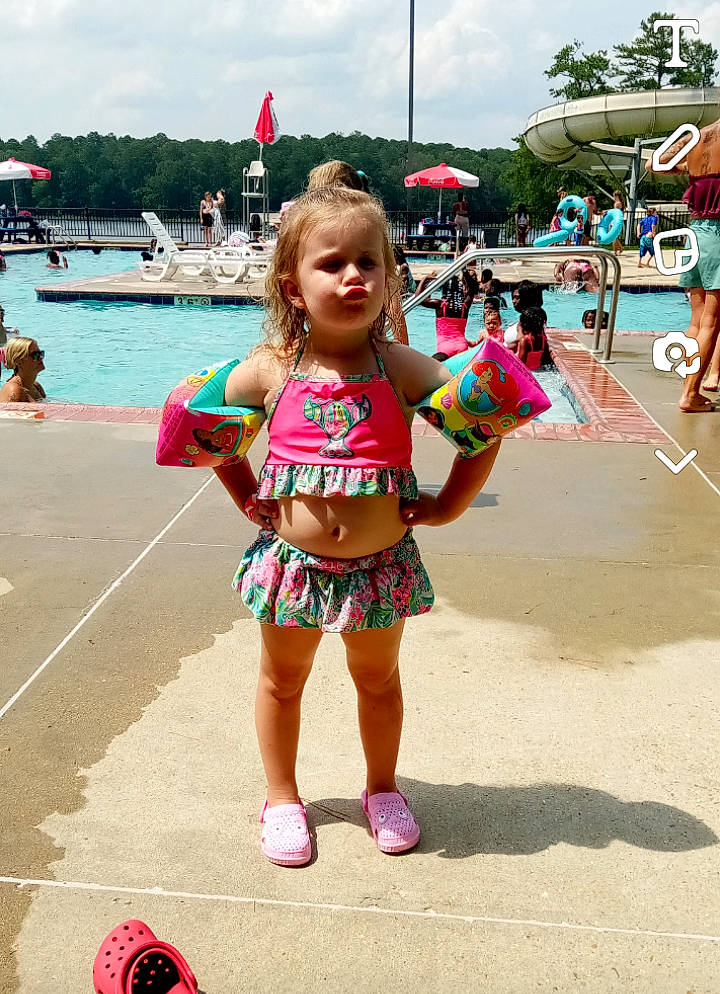 Charleigh is registered to the contest to win money with this photo: brassiere, child, cloud, event, fun, happy, human_leg, leisure, person, pink, play, recreation, shorts, sky, smile, swimsuit_top, thigh, toddler, travel, tree