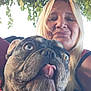 Chato joined the competition — help win amazing prizes! woman, dog, french_bulldog, selfie, outdoor, tree, leaves, pet, tongue_out, blonde_hair, face, canine, nature, closeup, happy, person, animal, daylight, smile, casual