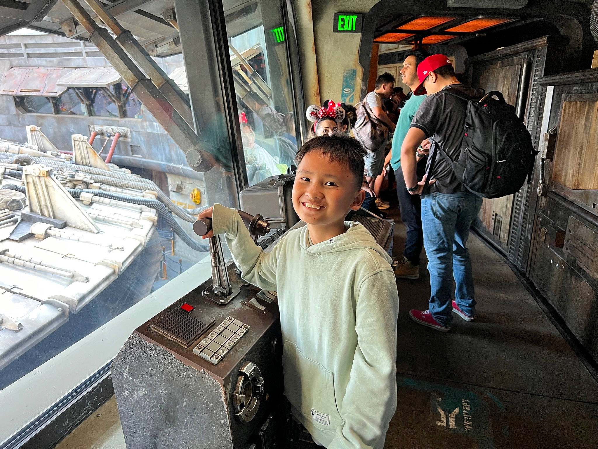 Shia is registered to the contest to win money with this photo: aerospace_engineering, backpack, bag, city, customer, engineering, fun, job, joy, luggage_and_bags, machine, passenger, person, public_transport, smile, standing, t_shirt, toddler, tourism, transport