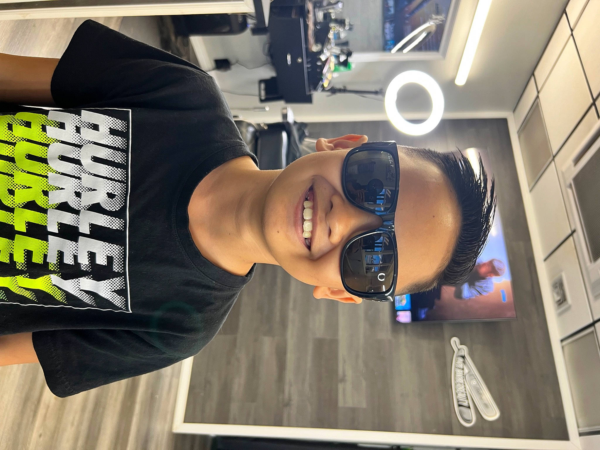 Shia is registered to the contest to win money with this photo: advertising, audio_equipment, automotive_design, elbow, eyewear, font, fun, headgear, job, joy, machine, person, personal_protective_equipment, room, smile, sportswear, sunglasses, t_shirt