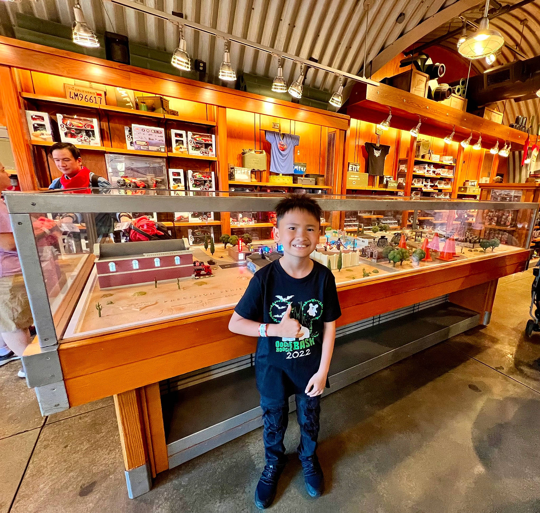 Shia is registered to the contest to win money with this photo: building, convenience_store, customer, flooring, food, fun, grocery_store, hardwood, joy, leisure, machine, orange, person, product, recreation, retail, shelf, shelving, smile, t_shirt