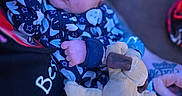 Aiden is registered to the contest to win money with this photo: baby, sleeping, plush_toy, onesie, hand, person, blue_lighting, indoor, closeup, face, infant, peaceful, cuddle, soft_toy, child, portrait, young, cozy, resting, cute