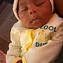 Mekhi joined the competition — help win amazing prizes! baby, sleeping, infant, onesie, cap, yellow, white, peaceful, cute, child, portrait, hands, soft_lighting, indoor, person, closeup, young, resting, adorable, cozy