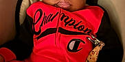 Mekhi joined the competition — help win amazing prizes! baby, infant, child, face, clothing, red_outfit, black_sleeves, pacifier, pacifier_clip, car_seat, person, portrait, cute, young_child, indoors, seated, expression, wide_eyes, hand, soft_lighting