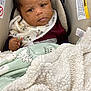 Mekhi is registered to the contest to win money with this photo: baby, bib, blanket, car_seat, child, clothing, cozy, cute, expression, face, furniture, head, indoor, infant, mickey_mouse, person, portrait, seatbelt, soft_texture, young_child