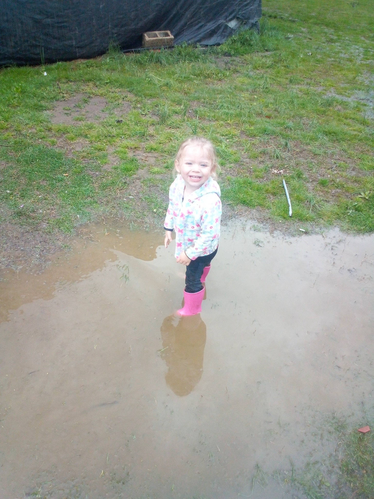 Rebel is registered to the contest to win money with this photo: asphalt, baby, child, concrete, fun, grass, joy, landscape, leisure, person, play, puddle, recreation, reflection, road_surface, sand, smile, soil, t_shirt, toddler