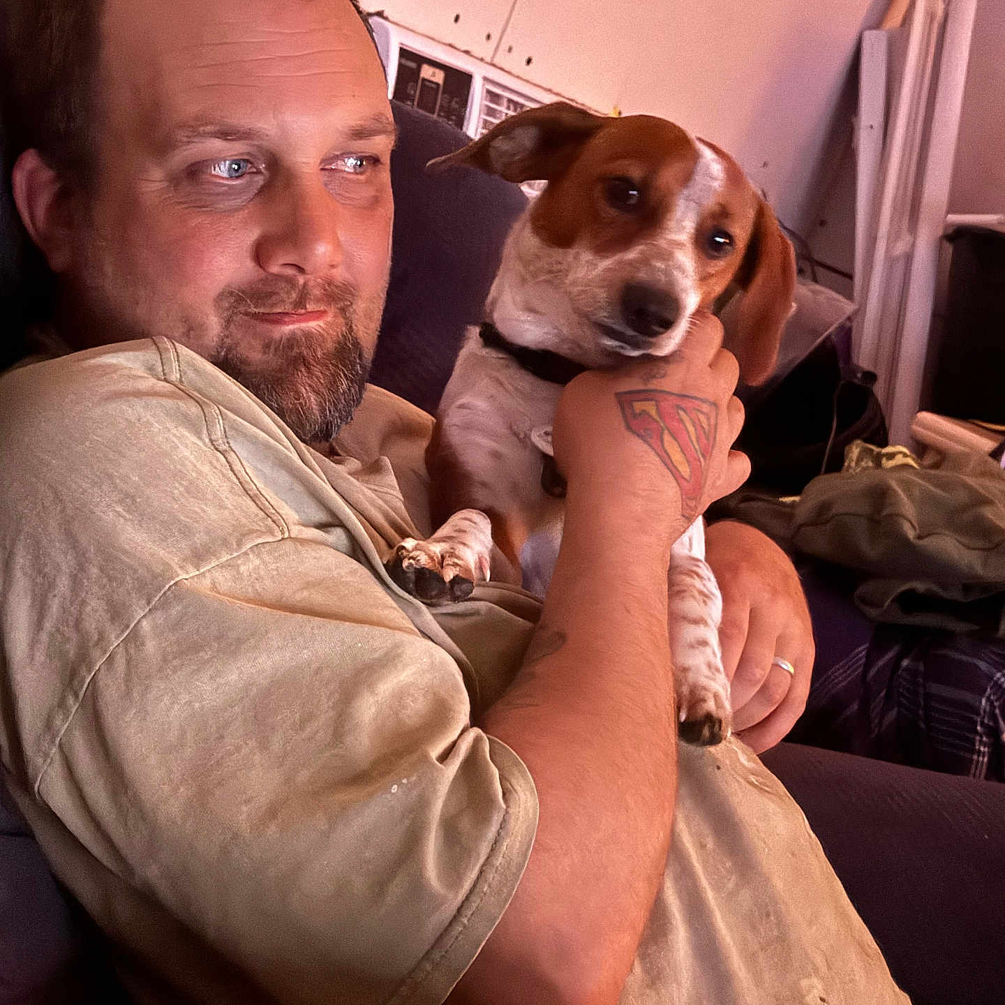 Duke is registered to the contest to win money with this photo: adult, animal, bodypart, canine, couch, dog, face, finger, furniture, hand, head, hound, male, man, person, pet, photography, portrait, skin, tattoo