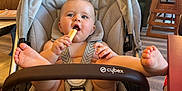Nina-Rose participe au concours pour gagner de l'argent avec cette photo : baby, stroller, snack, indoor, cafe, child, food, happy, feet, seatbelt, diaper, light, wall_art, table, chair, person, wood_floor, casual, playful, smiling
