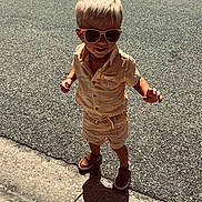 Weston joined the competition — help win amazing prizes! toddler, child, blonde_hair, sunglasses, shorts, shirt, banana_print, shoes, sidewalk, street, shadow, sunny, outdoor, smiling, walking, summer, casual_clothing, happy, person, daytime