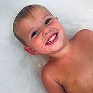 Weston is registered to the contest to win money with this photo: child, smiling, bathtub, water, wet_skin, happy, young, face, head, shoulder, skin, bath, childhood, portrait, person, candid, indoors, relaxing, joy, playful