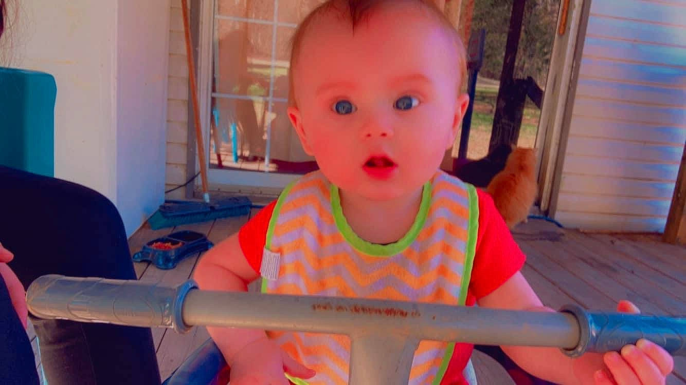 Kason is registered to the contest to win money with this photo: baby, baby_toddler_clothing, chair, child, city, flooring, fun, happy, houseplant, leisure, person, play, recreation, room, sitting, surprise, t_shirt, toddler, vacation, wood