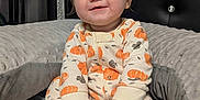 Oakley is registered to the contest to win money with this photo: baby, bed, child, comfort, cozy, cushion, cute, face, hands, happy, head, indoors, infant, pajamas, portrait, pumpkin_pattern, sitting, sleepwear, smile, soft_toy