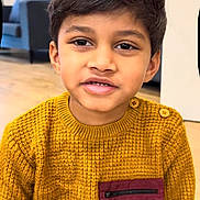 Rayaan joined the competition — help win amazing prizes! child, boy, sweater, yellow, indoor, portrait, face, smile, hair, button, pocket, floor, furniture, couch, modern, person, casual, cute, young, expression