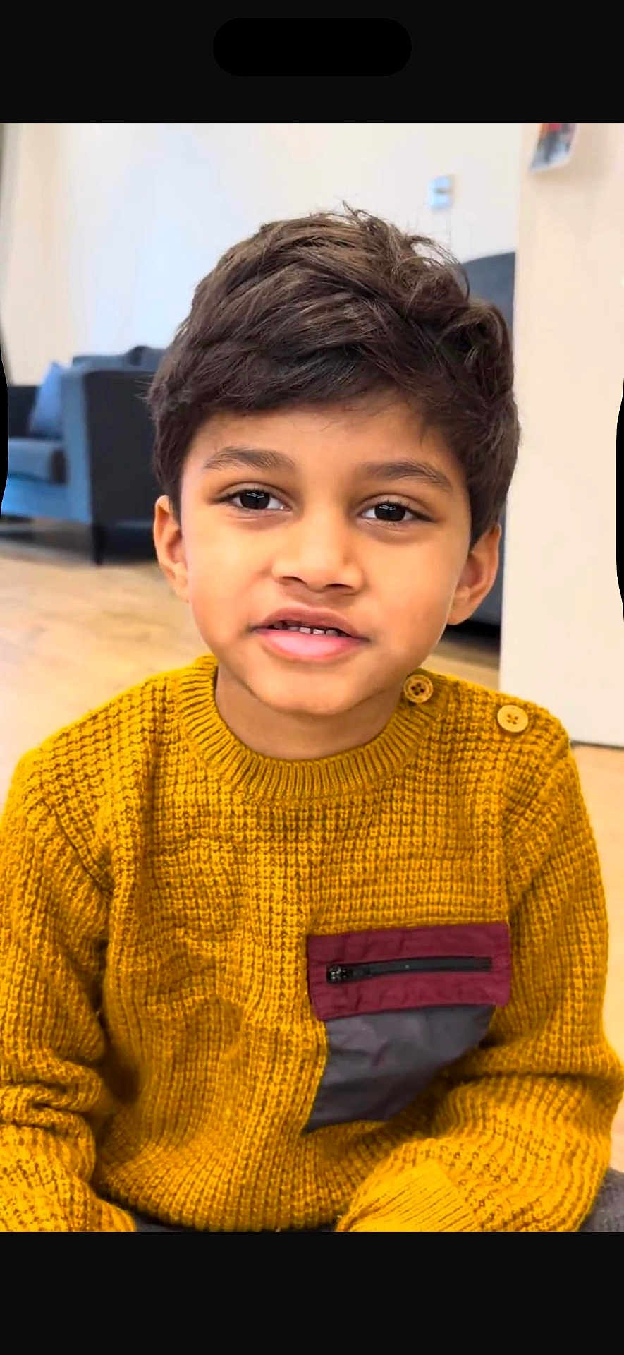Rayaan joined the competition — help win amazing prizes! child, boy, sweater, yellow, indoor, portrait, face, smile, hair, button, pocket, floor, furniture, couch, modern, person, casual, cute, young, expression