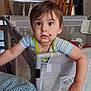 toddler, child, baby, playpen, face, birthmark, arm, hand, chair, dining_room, window, curtain, table, furniture, indoor, person, curious, clothing, striped_shirt, home