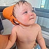 Corbin is registered to the contest to win money with this photo: baby, child, diaper, orange_bucket, hat, playpen, toy, indoor, curious, smiling, skin, blue_eyes, hair, face, expression, candid, cute, infant, person, play