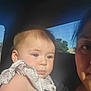baby, child, infant, person, face, earrings, sunlight, car, window, sky, trees, adult, clothing, floral_pattern, portrait, closeup, human, cute, young, inside