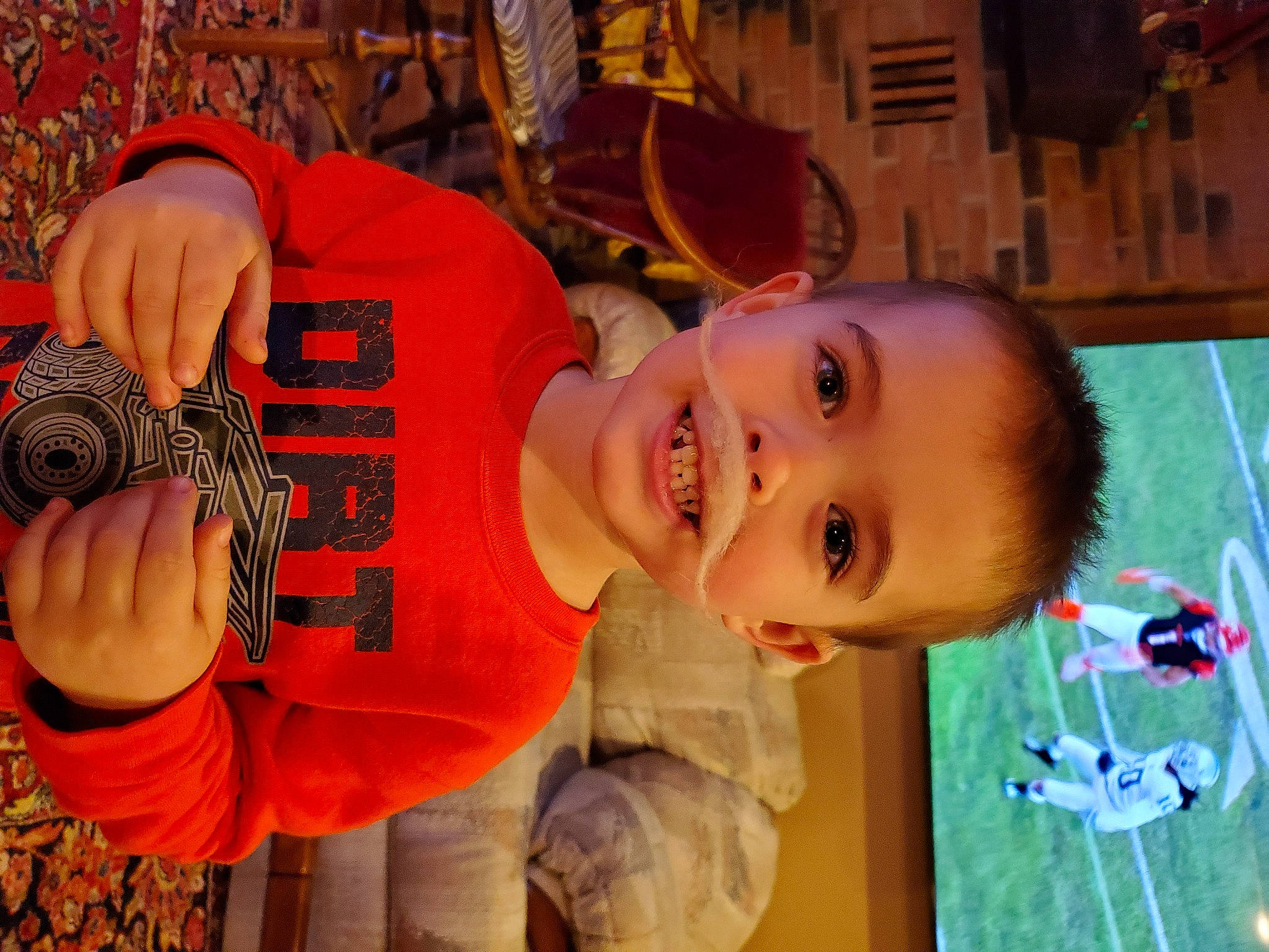 Liam is registered to the contest to win money with this photo: baby, baby_toddler_clothing, calabaza, cheek, child, facial_expression, fun, grass, happy, leisure, mouth, nose, orange, organ, person, room, smile, t_shirt, toddler, wood