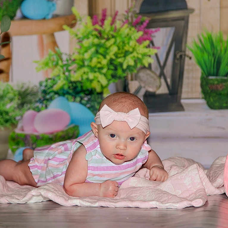 Oaklynn is registered to the contest to win money with this photo: baby, clothing, cushion, face, flower, flowerarrangement, hat, head, homedecor, jar, person, photography, plant, planter, portrait, pottedplant, pottery, sitting, vase, wood
