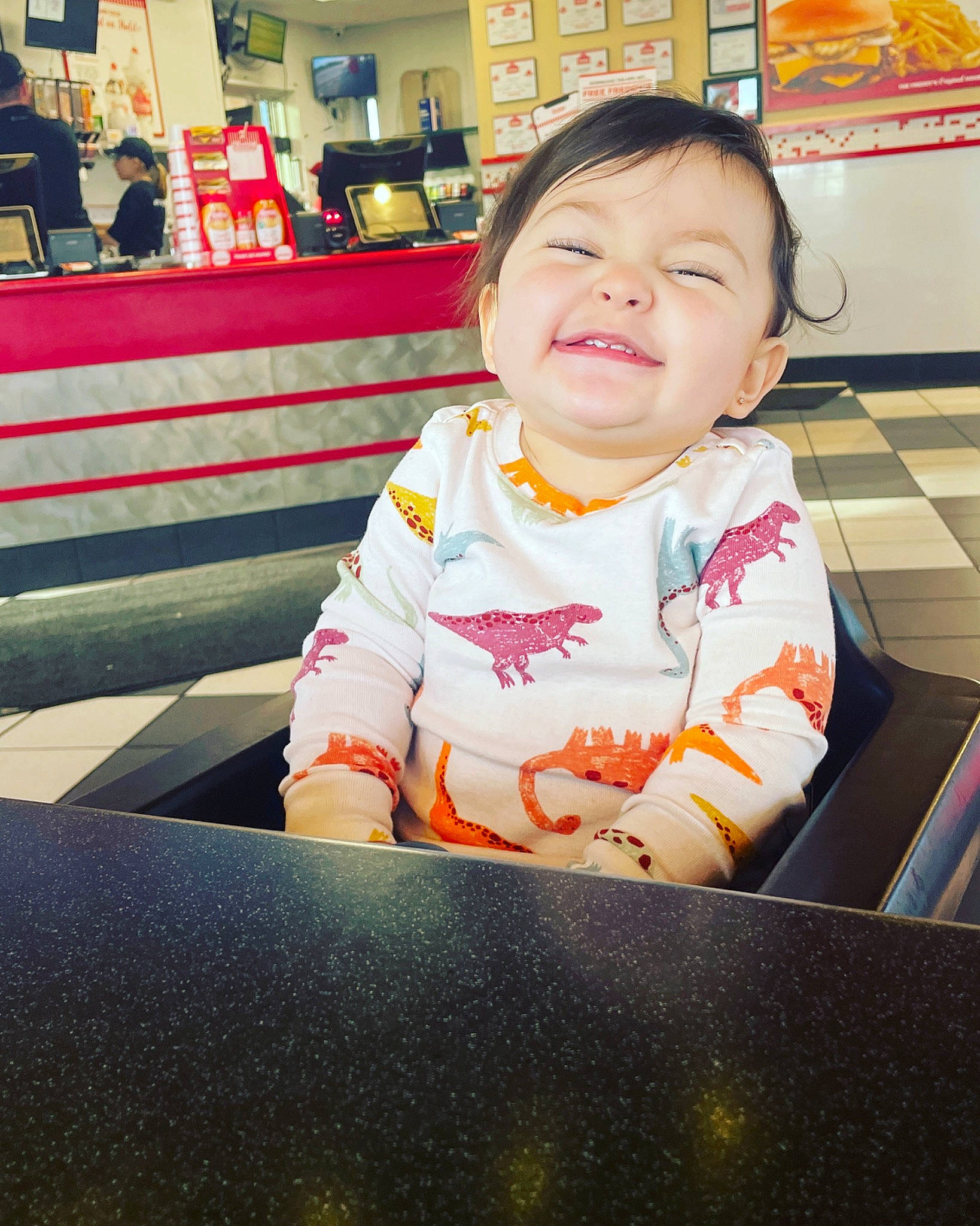 Kataleya is registered to the contest to win money with this photo: baby, baby_toddler_clothing, cheek, child, facial_expression, fun, happy, houseplant, leisure, person, room, sitting, sleeve, smile, standing, t_shirt, toddler, travel